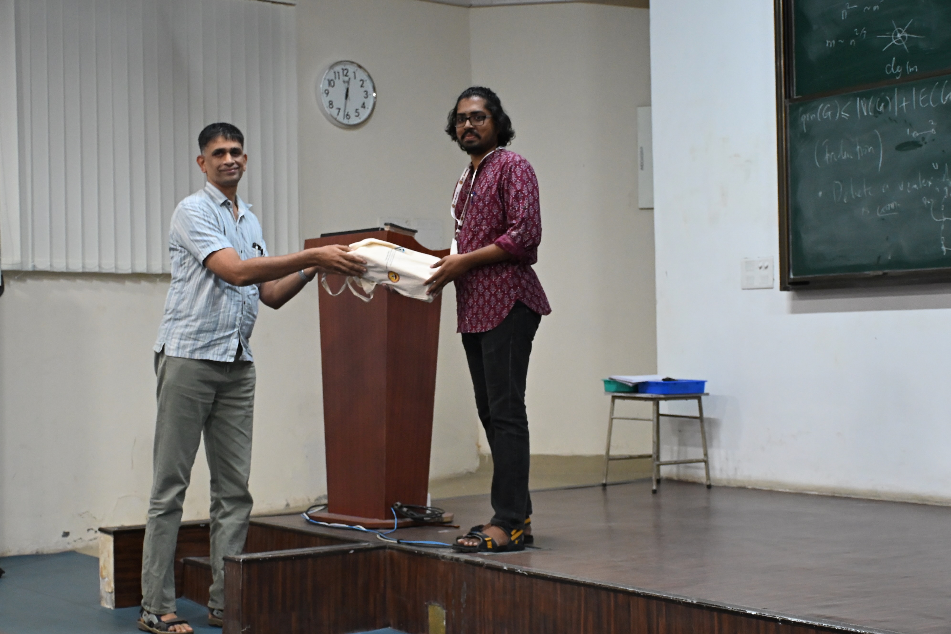 Receiving a memento from the session chair Raghavendra Rao B. V. (IIT Madras)